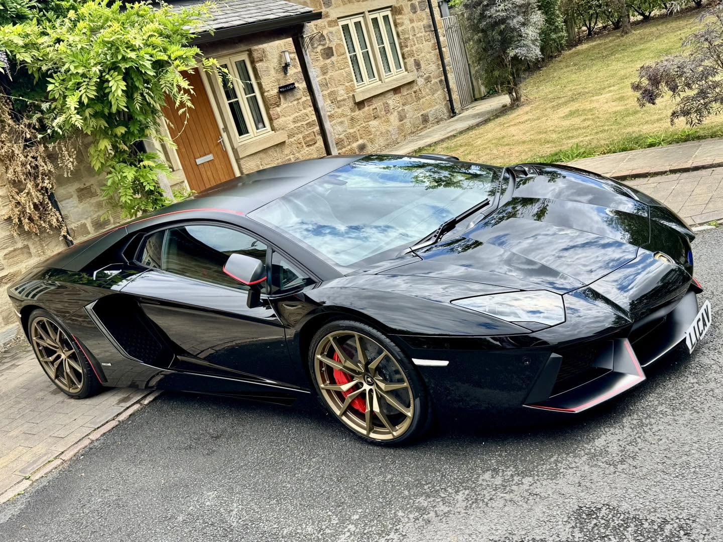 Black Lamborghini Aventador with bronze wheels after a gloss enhancement detail